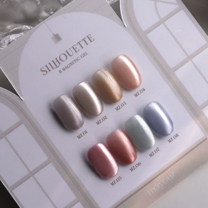 Eight metallic and holographic nail polish colors from the MAYOUR Silhouette Collection, displayed on a white card background.