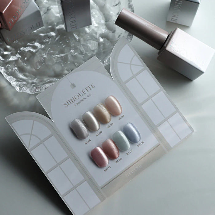 A sophisticated collection of magnetic gel nail polishes in a variety of shimmering shades, featuring a sleek, minimalist packaging design and a convenient magnet for easy, at-home nail art.