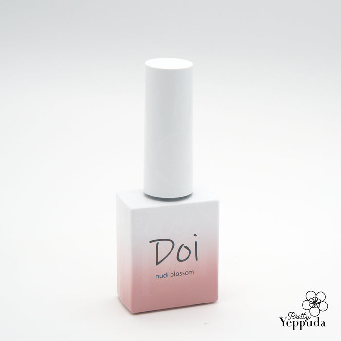 A beautifully designed nail gel polish bottle in a trendy gradient color, showcasing the NAILBAYO brand and the "Doi Nudi Blossom" product. The sleek, minimalist packaging highlights the high-quality Korean nail supply product, which is suitable for both professional and beginner nail enthusiasts seeking a buildable, self-leveling gel formula in a delicate blossom hue.