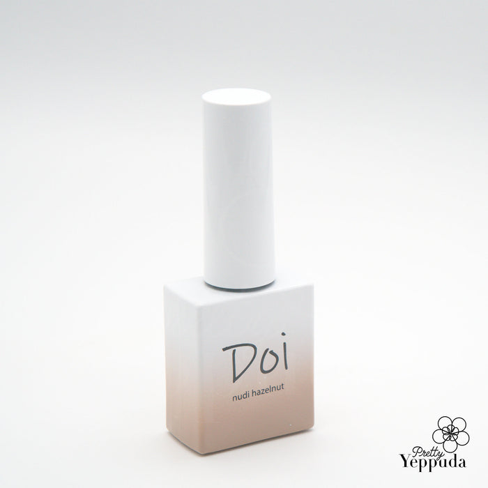 A close-up image of a white and beige bottle labeled "Doi nudi hazelnut" by the renowned Korean nail artist brand NAILBAYO. The bottle showcases the Doi syrup gel base color, known for its excellent self-leveling properties and ease of application for both professionals and beginners in the world of nail art and design.