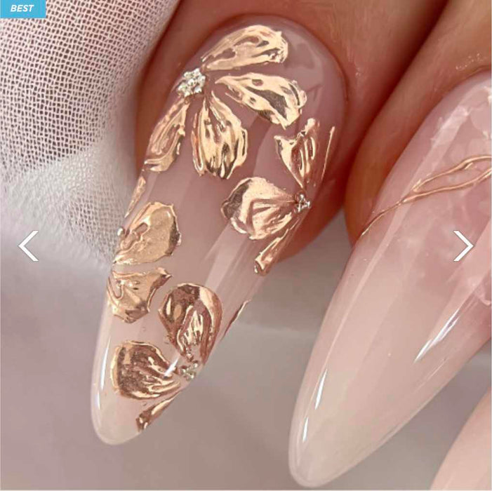 Elaborative alt text for the image of the Nailbayo Doi Tong Gel #3 product: Beautifully manicured nails showcasing the striking Nailbayo Doi Tong Gel #3 product, featuring a stunning design with intricate gold floral patterns adorning the translucent nail polish. The gel formula promises a high-shine, long-lasting finish that perfectly captures the essence of the renowned Korean nail artist Nailbayo's signature style. This captivating Nailbayo na