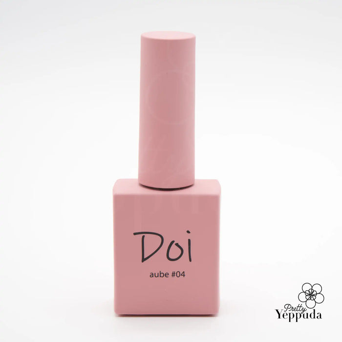 A close-up image of a pink nail polish bottle labelled "Doi aube #04 - 10ml" from the Korean nail supply brand NAILBAYO. The bottle has a distinctive square shape and appears to be made of smooth, matte material. The product is marketed as a HEMA-free colored builder gel or colored overlay gel, highlighting its use for nail art and enhancement.