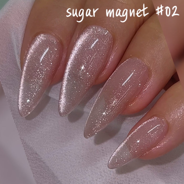 A close-up image of the "Nailbayo DOI Sugar Magnet Gel Collection 6pcs/set", featuring shimmering, pearl-like polished nails with a metallic, magnetic effect. The nails display an elegant, lustrous finish, showcasing the high-quality and eye-catching nature of this Korean nail supply product by the renowned artist NAILBAYO. This visually striking image effectively highlights the product's key features and unique selling points, such as its use of