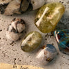 Assortment of gemstones including green and yellow crystals, showcasing the natural beauty and elegance of the BEVLAH Tutorial Vol. I Gemstone Collection.