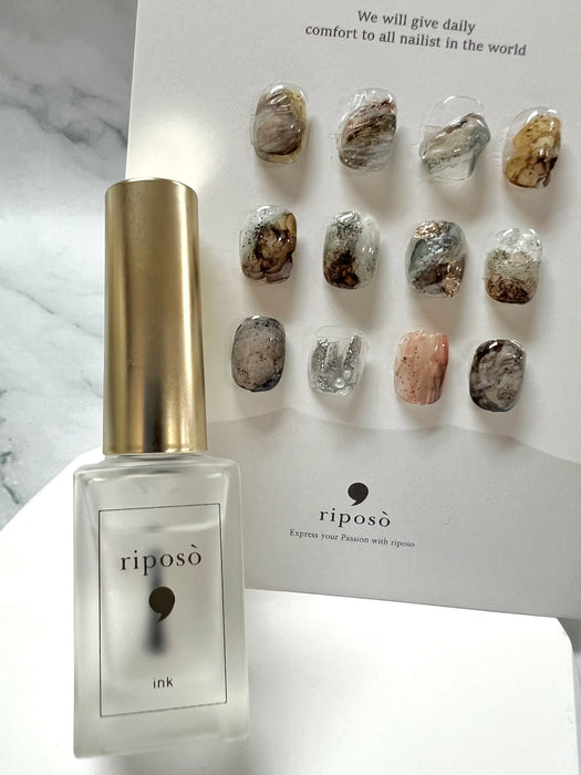 A bottle of RIPOSO ink blender with a natural, marble-like aesthetic, showcasing the versatility and versatility of the product for creating unique and visually striking art with ink.