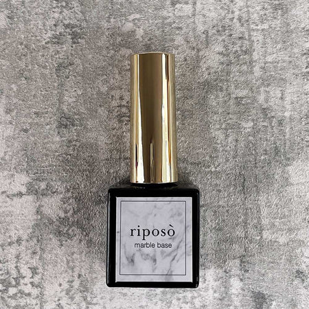 A high-quality, marble-based gel nail polish bottle with a metallic gold cap, prominently displaying the "RIPOSO" brand name against a marble-inspired background, creating a sophisticated and luxurious aesthetic for this versatile base gel product.