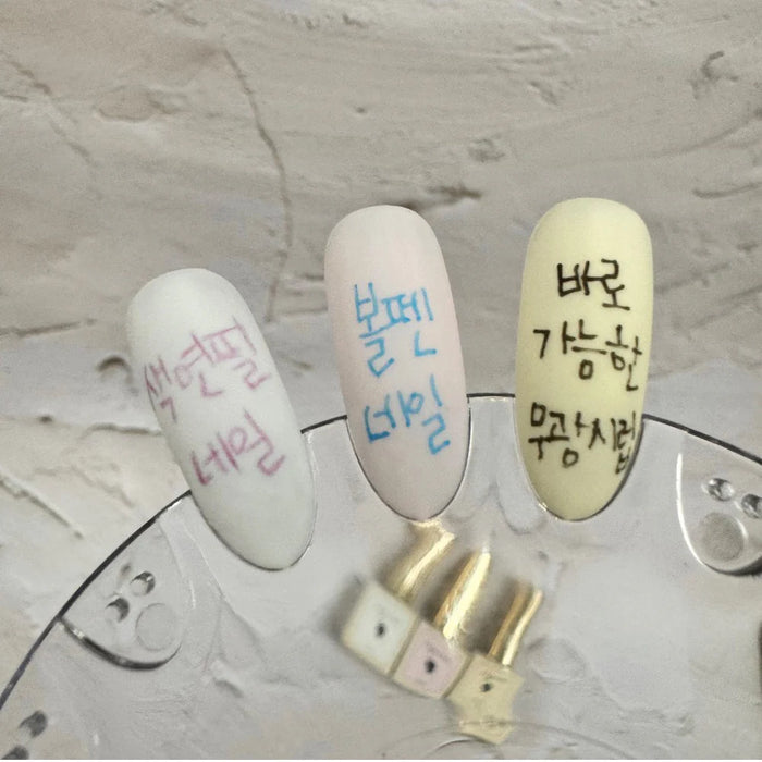 The image depicts a close-up shot of three matte syrup gel nail polish bottles in the colors white, pink, and yellow. The bottles feature Korean text and designs, highlighting the Riposo brand and the product's key features, such as its ability to allow users to create doodle nail art without the need for a matte top coat or sanding. This colorful and intricately designed product showcases the brand's innovative nail care solutions, catering to t