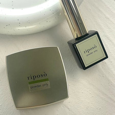 Powder gel bottle and container displayed in a minimalist, elegant manner, showcasing the Riposo brand and its "Powder Only" gel product.