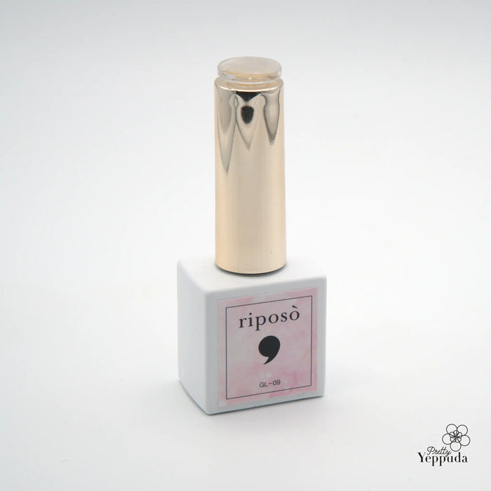 Elegant gold-toned nail gel bottle with reflective surface, part of the premium Veil Glinting collection by Riposo, featuring a mixture of subtle gold glitters and colors that complement Swarovski nails, with a delicate and soft application for a classy and luxurious look.