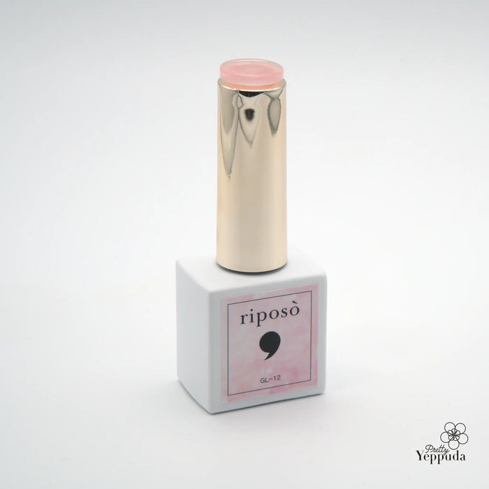 Alt text: Elegant and sophisticated cosmetic product from the Riposo brand, featuring a glossy, metallic gold-colored container with a pale pink cap, showcasing the "Veil Glinting" collection of premium glitter nail syrup.