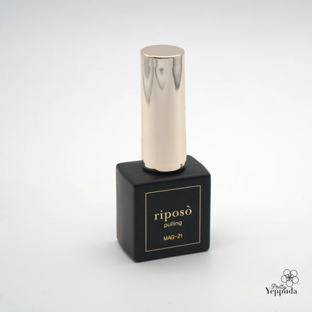 Elegant and captivating metal gel nail polish bottle from the Riposo Pulling Gleam Collection, featuring a sleek silver applicator and a black matte base adorned with the brand's iconic logo. This one-step magnetic gel formula allows for effortless powder nail art, simplifying the process and delivering a stunning, gleaming finish.