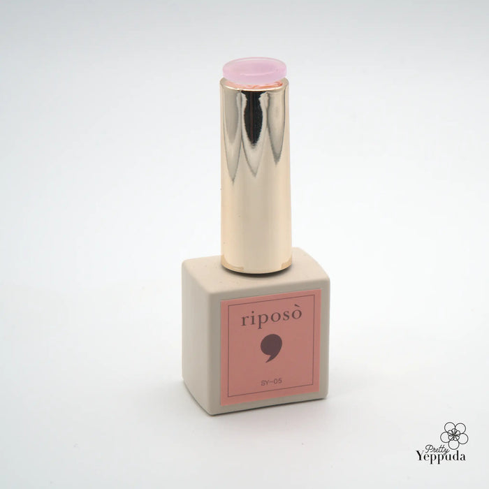 A bottle of Riposo Love Love Syrup A Set, a 5-piece non-wipe syrup gel collection in sheer nude shades, designed for the perfect natural-looking nails. The product features a sleek, metallic container with a pink cap, showcasing the brand's minimalist and elegant aesthetic.