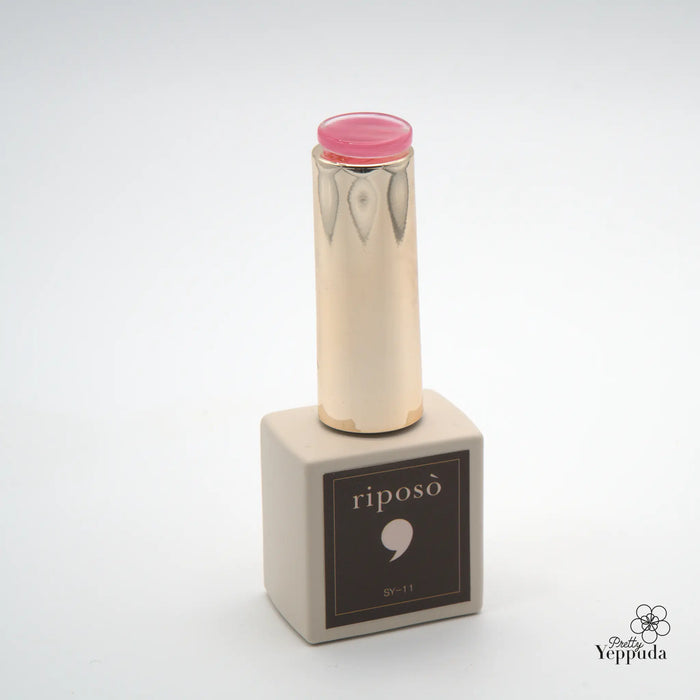 A captivating image of the RIPOSO Love Love Syrup C Set, featuring a sleek and modern design with a striking cylindrical bottle in a soft, neutral tone. The vibrant pink cap adds a touch of elegance, hinting at the deep, sensuous shades within. This set promises a unique non-wipe finish, allowing for seamless application of chrome powder, perfect for creating a luxurious and sophisticated mood anytime.