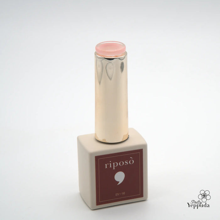 The image shows a transparent pink lip gloss product from the RIPOSO Love Love Syrup D Set collection. The product features a soft, transparent color that can be built up for varying intensity, providing a wet-look lip tint effect. The alt text could be: "A transparent pink lip gloss product from the RIPOSO Love Love Syrup D Set, offering a buildable, wet-look lip tint effect.