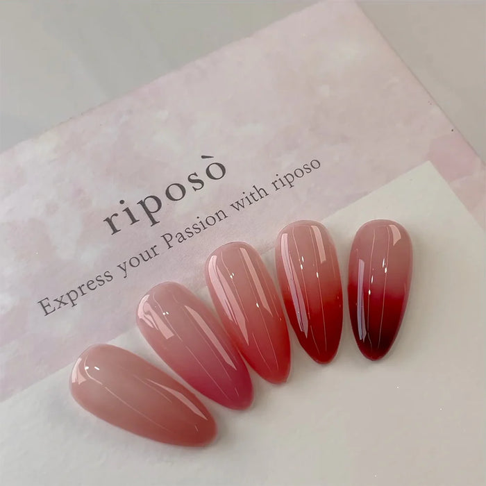 Vibrant and captivating gel nails featuring a gradual ombre effect, transitioning from a soft nude to a rich, bold red - the RIPOSO Love Love Syrup D Set showcases the brand's innovative color-shifting technology, allowing users to create a unique and personalized look with just a few swipes. This visually striking image highlights the product's ability to deliver a versatile, wet-look lip glow in a range of alluring shades.