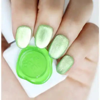 Ten vibrant and shimmering green-colored cateye gel nail polish bottles from the SHOW ME KOREA Cooing Prism Collection, showcasing a captivating and bold nail art design aesthetic perfect for saturated, rainbow-inspired nail looks. The products offer a UV/LED 30-second curing time and do not include a magnetic component, ensuring a simplified and user-friendly application process.