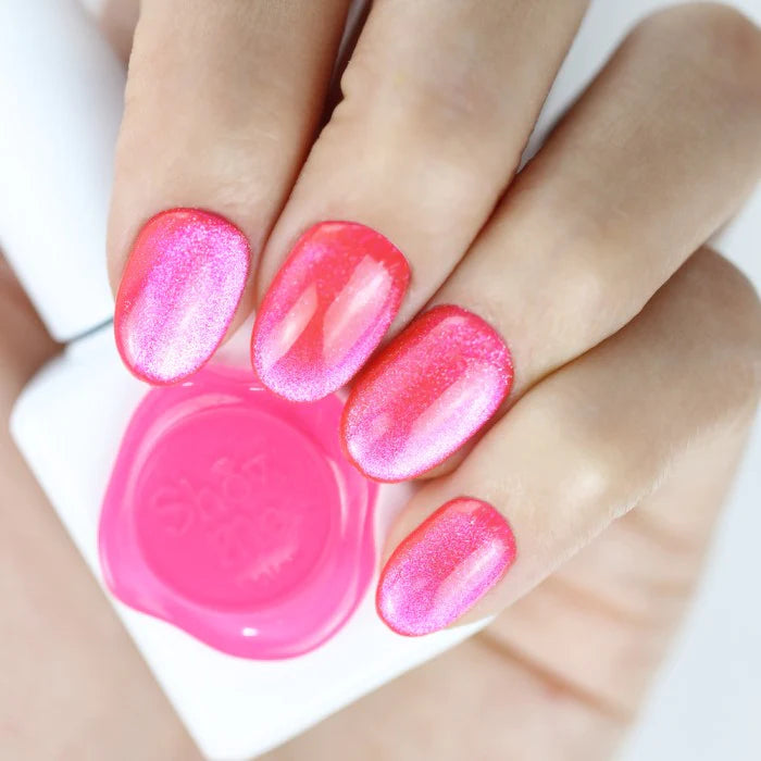 This image showcases a set of vibrant, bold, and electrifying cat-eye gel nail polishes from the Show Me Korea brand's Cooing Punch Collection. The nails are painted in a striking neon pink shade, exuding a dynamic and captivating visual appeal. The glossy and reflective finish of the gel polish adds depth and dimension to the nails, creating an eye-catching and attention-grabbing display.