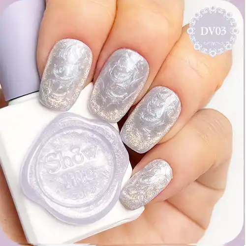 Elegant pearly white nails with a delicate threaded pattern, featuring a shimmering cateye effect achieved through the use of a magnet. This high-quality gel polish from the popular Korean brand "Show Me Korea" offers a unique and visually captivating nail design.