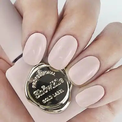 A close-up image of a person's hands showcasing a bottle of nail polish from the "Show Me Korea" Edge Collection. The polish bottle features a sleek, minimalist design in a neutral beige hue, perfectly capturing the essence of the classic, nude-inspired looks that the collection is known for. The product promises rich pigmentation and easy application, making it a must-have for all nail enthusiasts seeking a timeless, elegant aesthetic.