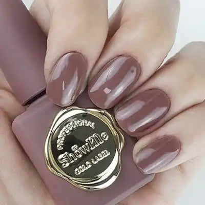 A manicured hand displaying a bottle of Show Me Korea's Edge Collection nail polish in a classic nude color. The image showcases the high-quality pigmentation and smooth application of this product, making it suitable for a variety of nail art designs and looks. Show Me Korea, as a leading brand in the cosmetics industry, offers a curated selection of nail gels that provide long-lasting wear and a professional finish.