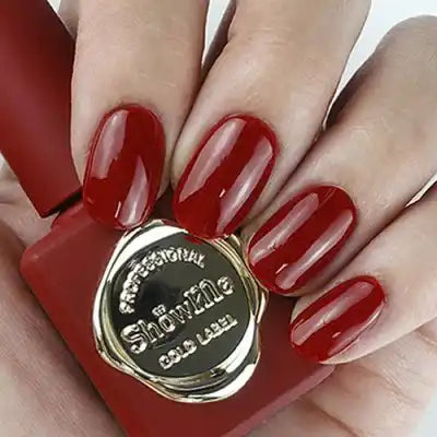 A close-up image of neatly manicured, glossy red fingernails, showcasing the "Show Me Korea" - Edge Collection nail polish product. The rich, vibrant red color of the nail polish stands out prominently, highlighting the high-quality formulation and exceptional pigmentation. This classic, sophisticated nail color is perfect for a range of looks, from bold and dramatic to soft and natural. The product details emphasize its versatility and ease of a