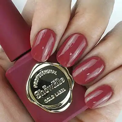 An image of a woman's fingernails painted with a deep, rich red nail polish from the "Show Me Korea - Edge Collection". The high-quality gel formula provides opaque, pigmented color in just one brushstroke, creating a classic, sophisticated look for all nail enthusiasts. The product offers a 30-second UV/LED curing time, making it a convenient and long-lasting choice.