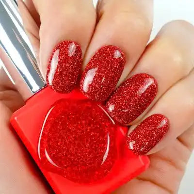 Sparkling red nails adorned with a vibrant Kitsch Collection nail polish, showcasing a dazzling and festive display reminiscent of fireworks. The image highlights the high-quality, glitter-infused formula of the "SHOW ME KOREA" Kitsch Flash Gel Collection, offering a captivating and eye-catching look.