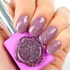 Dazzling, sparkling lavender nails showcasing the vibrant Kitsch Collection by Show Me Korea. The gel formula captivates with its glittering, firework-like effect, complementing the brand's commitment to unique, high-quality nail products.