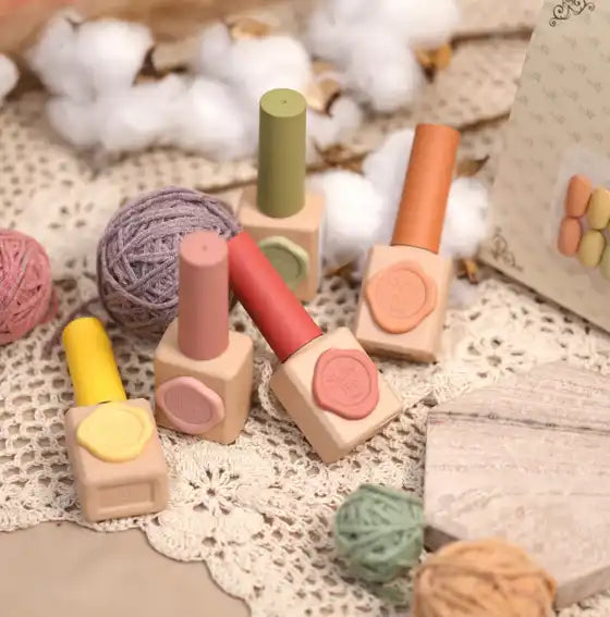 Colorful assortment of nail polish bottles and yarn balls in a vintage, cozy setting, showcasing the warm, retro aesthetic of the SHOWME Korea Purring Song nail gel collection.