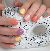 Vibrant and playful nail palette with a range of pastel and bold colors, including peach, yellow, lavender, green, and orange, showcasing the diverse hues of the "Purring Song" collection from the reputable SHOWME Korea nail brand. The nail designs feature a mix of solid colors, creating a whimsical and trendy aesthetic that captures the warm, vintage appeal of cats.