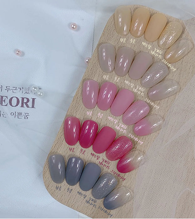 A collection of variously colored nail gels in syrupy, translucent shades with a slight pearlescent finish, showcasing the diversity of the Yeori Yeori Collection by Show Me Korea. The image displays an array of pink, mauve, and gray hues, highlighting the brand's attention to detail and range of options for the discerning nail enthusiast.