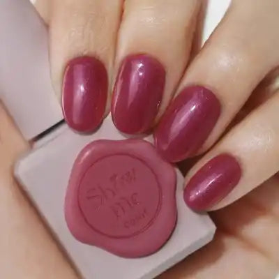 Elaborative Alt Text: A collection of nine vibrant nail gel colors in a syrupy, pearlescent finish, including a glitter overlay gel, from the Yeori Yeori Collection by the Korean beauty brand SHOW ME KOREA. The image showcases a set of well-manicured hands displaying one of the rich, glossy nail polish shades from the collection.