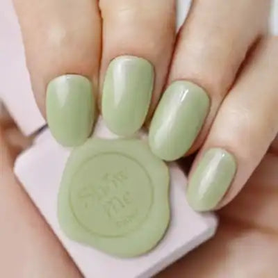 A close-up image of a person's hands displaying a set of pastel green nail polish bottles from the SHOW ME KOREA - Yeori Yeori Collection. The nail polish bottles feature a syrup-like consistency with a slight pearlescent finish, as described in the product details. The image showcases the vibrant and trendy colors of this Korean-inspired nail gel collection.