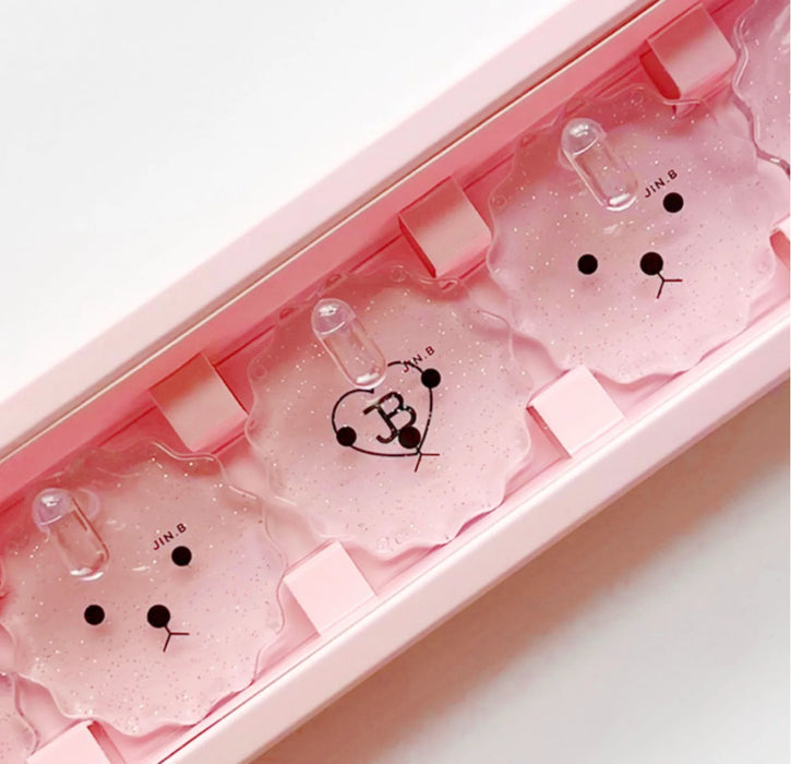 A pink nail tip stand set with five adorable bear-shaped holders, perfect for practicing and creating favorite nail designs with the Jin.B brand featured in the original pink packaging.