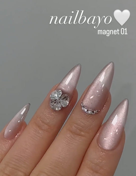 Detailed alt text for the image of the Nailbayo DOI Magnet Gel #1 - 10ml product:

Elegant and intricate nail art adorned with the Nailbayo Magnet Gel #01, a premium Korean nail product featuring a stunning floral design accented by sparkling rhinestones. The nails showcase a lustrous, metallic pink finish that shimmers under the light, creating a captivating and visually striking appearance. This specialized gel formula requires the use of a mag