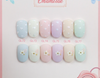 Elegant and whimsical pastel nail polish gels featuring a variety of soft, dreamy shades in the SHOWME Korea Emamttae Syrup Collection, with delicate floral accents for a refined, professional look.