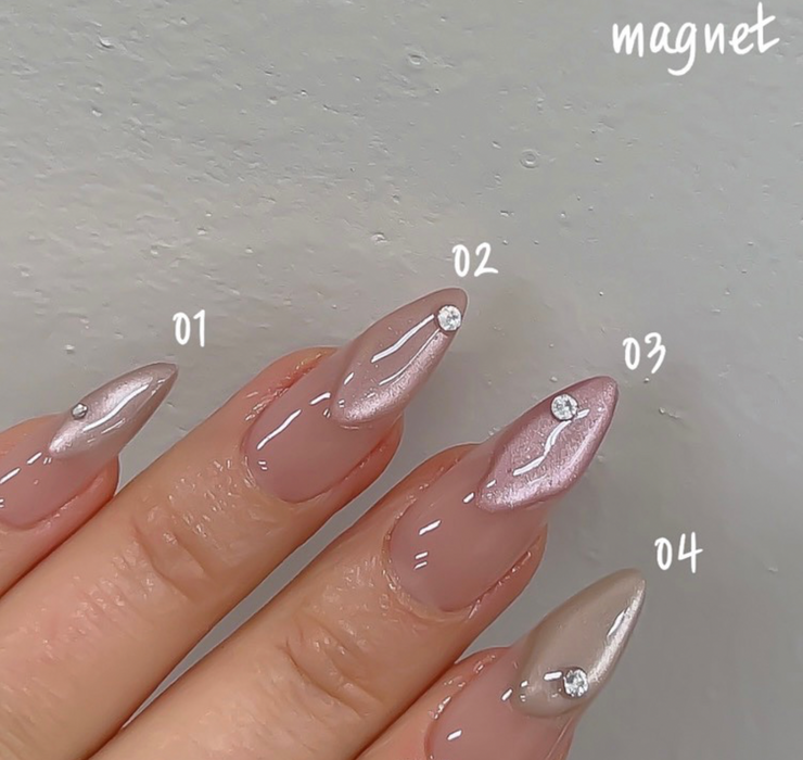 A close-up image of a person's manicured fingernails featuring four different shades of nail polish, ranging from light peach to a deeper nude color. The nails have a glossy, gel-like finish, and the image showcases the various numbered shades of the "Nailbayo DOI Magnet Gel # 4" product.