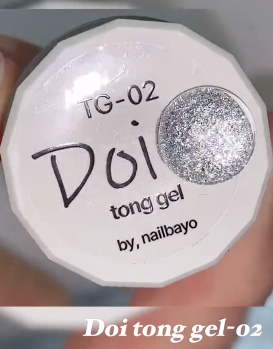 Elaborative alt text: The image depicts a Shopify product named "Nailbayo Doi Tong Gel #2", a Korean nail supply by the famous nail artist Nailbayo. The product appears to be a tong gel with a "crazy amount of glitter" as described in the product details. The image showcases the gel's packaging, which prominently displays the brand name "Nailbayo" and the product name "Doi tong gel-02". The product size is 5g, making it a convenient and versatile