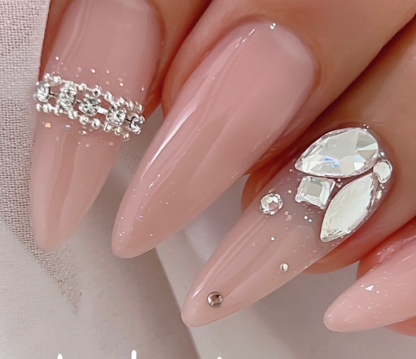 Sparkling and glamorous nails adorned with transparent glitter and rhinestone accents, showcasing the luxurious Nailbayo DOI Sugar gel product featured in this Shopify offering. The intricate nail art design evokes a high-end, Korean-inspired aesthetic that is both stylish and on-trend.