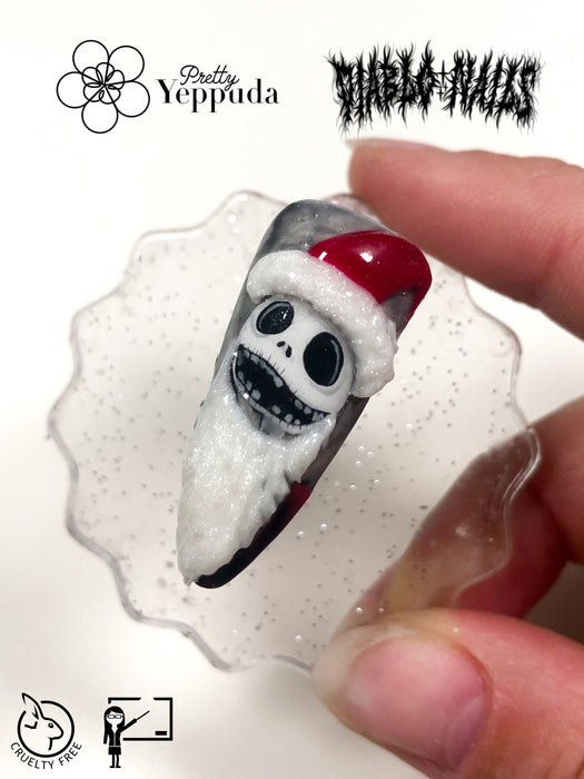 Jack Skellington nail sticker in Santa suit held by fingers, showcasing Pretty Yeppuda and Diabl0Nails collaboration for live sticker seminar. Clear, detailed holiday-themed nail art design demonstrating product quality and creative potential for upcoming tutorial.