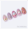 Elegant, delicate, and alluring nail art design featuring cute crowns, ribbons, and heart silhouettes in a charming pastel color palette, showcasing the exceptional craftsmanship of the Tsumekira brand.