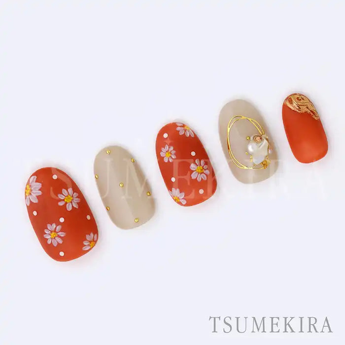 A set of brightly-colored, intricately-designed nail art stickers from the premium Japanese brand Tsumekira. The stickers feature delicate white flowers against a vibrant orange background, creating a beautiful and eye-catching design that can be used year-round. The stickers are available in a variety of sizes to accommodate different nail shapes and sizes.