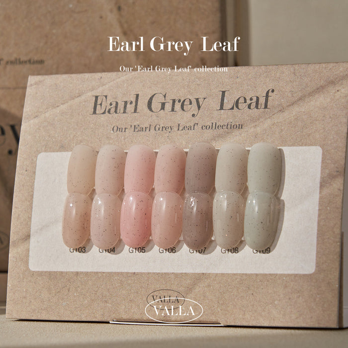 Display of VALLA Earl Grey Leaf collection swatches on a rustic paper background, showcasing a range of nine nail colors from soft pink to earthy gray, each labeled with its unique shade number.