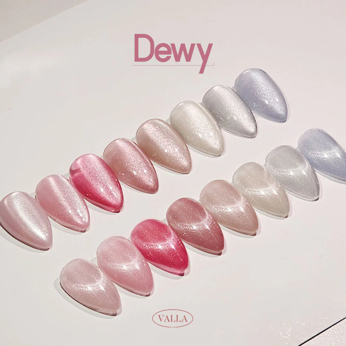 A colorful and visually appealing display of the VALLA Dewy Collection, featuring an array of shimmering, pearlescent gel nail polish shades ranging from soft pinks to silvery grays, creating a sophisticated and trendy "cat eye" effect.