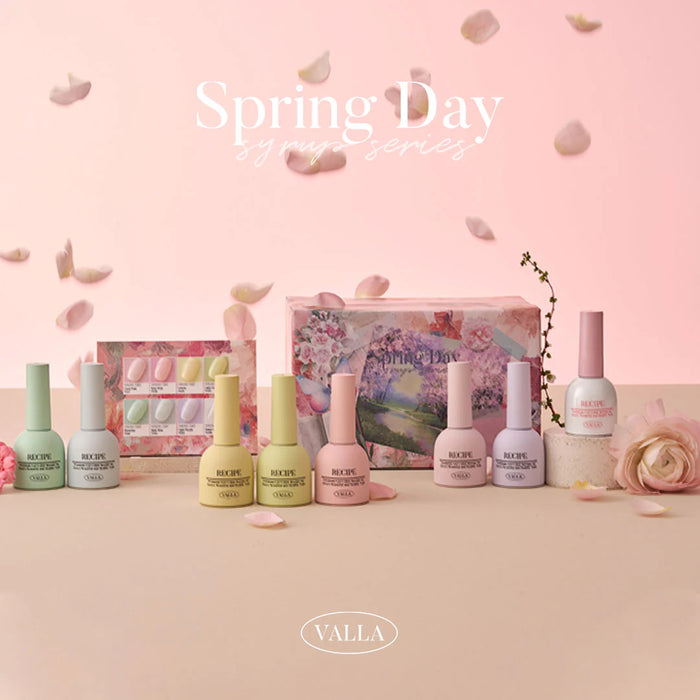 Vibrant spring-themed collection featuring an array of colorful syrup and glitter gel nail polish products by the VALLA brand, displayed on a soft pink background with scattered petals to convey the essence of a fresh, blooming spring day.