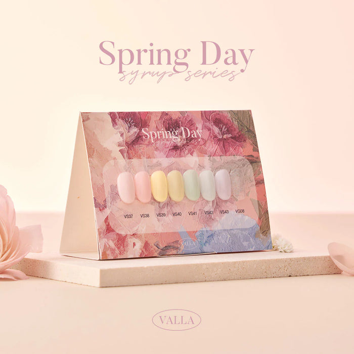 A vibrant display of the VALLA Spring Day Collection, featuring a variety of colorful nail polish shades ranging from coral pink to light purple, perfect for embracing the new season and celebrating the beauty of spring days. The image showcases the diverse selection of syrup and glitter gel polishes that allow customers to add a touch of warmth and vibrancy to their look.