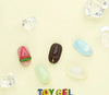 A playful collection of colorful, moldable toy gel pieces in various shapes and sizes, including a watermelon slice, a sandal, and translucent blocks, inviting creative 3D nail art and sculpting projects. This VALLA Toy Gel product offers a unique, pliable texture that can be easily manipulated while retaining some elasticity even when fully cured.