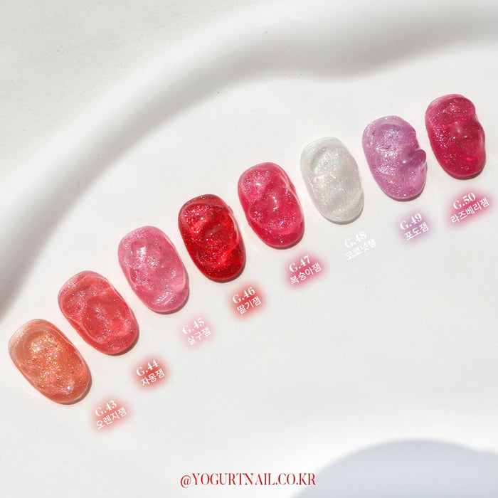 Dazzling array of vibrant, shimmering nail polish colors in the YOGURT JAM JAM Collection, featuring an 8-piece set of syrup-like glitter gels that capture the essence of juicy, fruity jams with their vivid hues and sparkling, lip-gloss-like finish, creating a captivating, on-trend nail art experience.