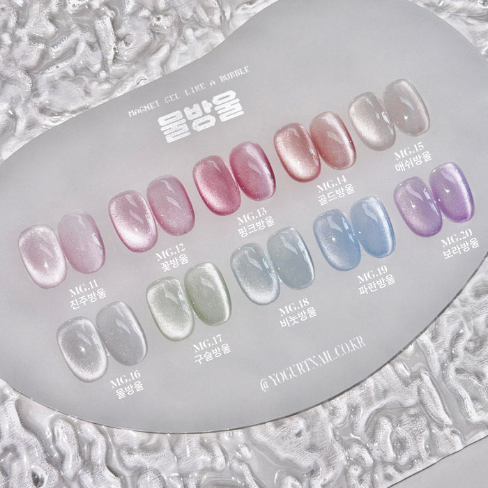 Detailed image showcasing a variety of colorful and shimmering nail polish shades, including pinks, purples, blues, and grays. The image provides a comprehensive display of the "YOGURT Bubble Magnet Gel Collection 10pcs/set" product, highlighting the diverse range of nail polish options available.