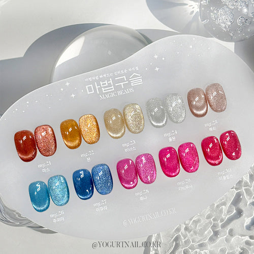 Vibrant array of colorful gel nail polish beads showcasing the diverse "YOGURT Magic Beads Collection" from the Shopify product. The 10-piece set features a spectrum of shimmering hues, ranging from warm tones of orange and gold to cool blues and pinks, allowing for customizable and eye-catching nail designs. The product details indicate 60-second UV/LED curing for a long-lasting, salon-quality manicure.